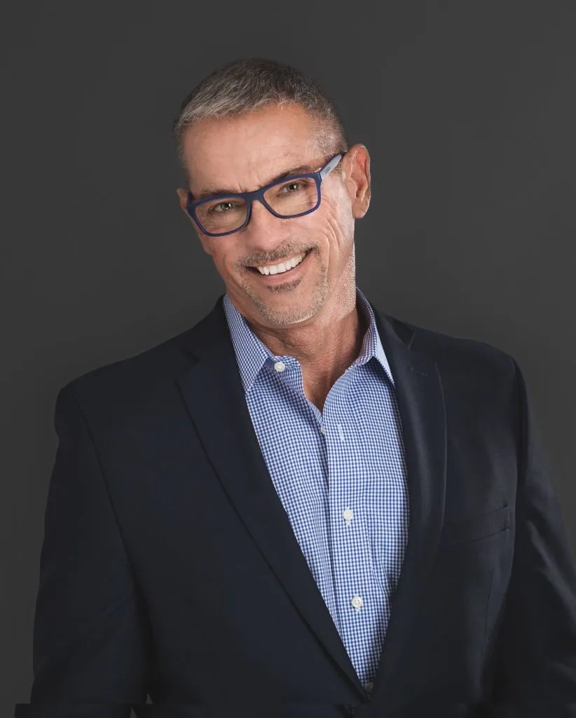 Bill Wagner, Realtor at REAL, San Francisco, in a navy blazer and blue glasses